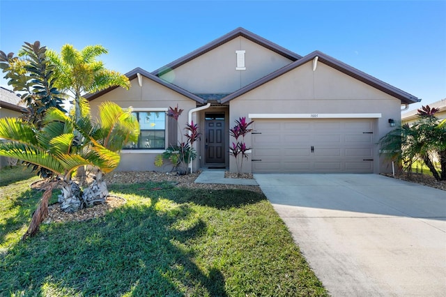 view of front of home featuring a front lawn and a garage