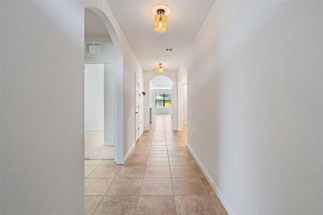 hall featuring light tile patterned floors