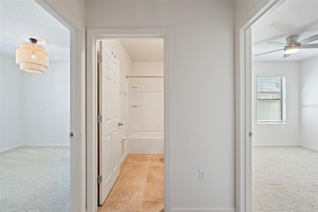 hall featuring light colored carpet