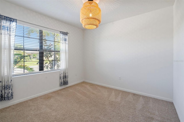 unfurnished room featuring carpet flooring