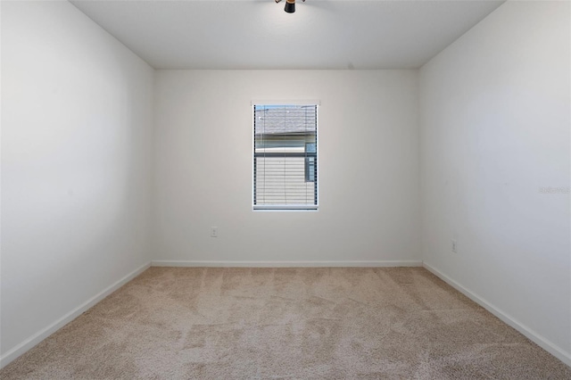 unfurnished room with light carpet