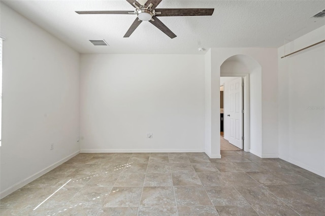 spare room featuring a textured ceiling and ceiling fan