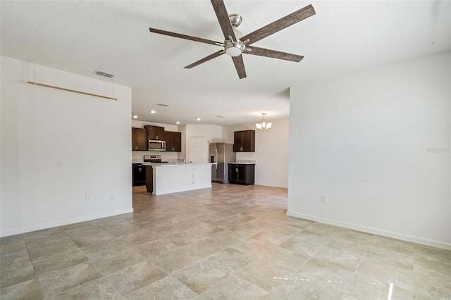 unfurnished living room with ceiling fan with notable chandelier