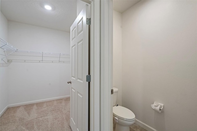 bathroom featuring toilet and a textured ceiling