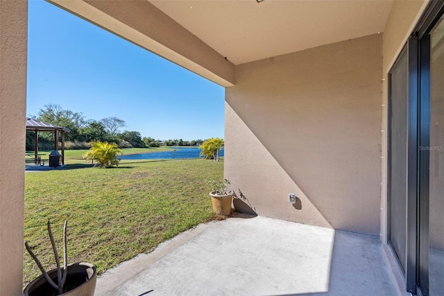 view of patio / terrace with a gazebo and a water view