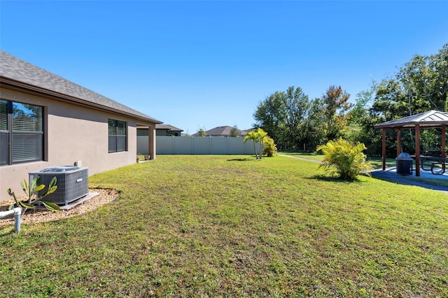 view of yard featuring a gazebo and central AC