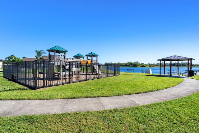 view of playground featuring a gazebo, a water view, and a yard