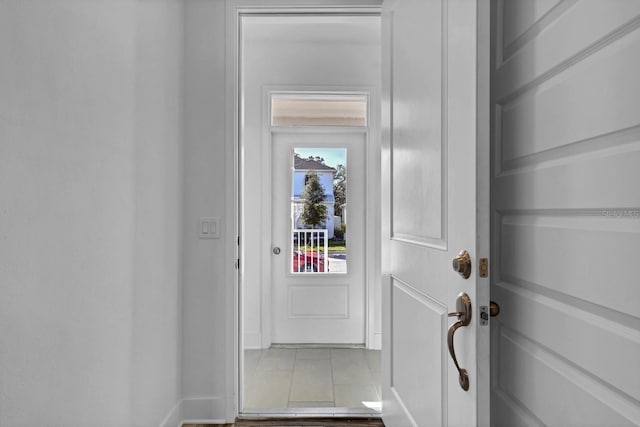 doorway featuring light tile patterned flooring