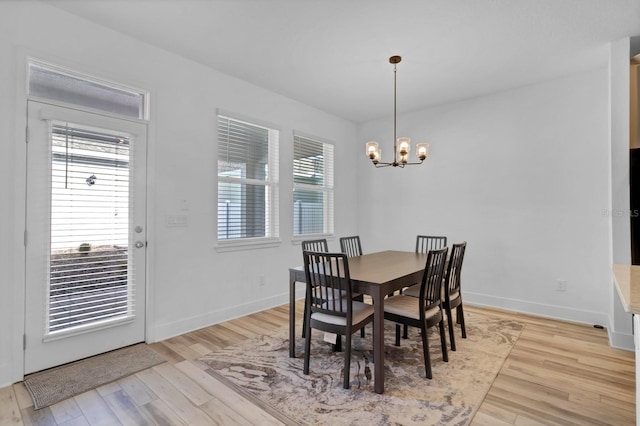 dining room featuring light hardwood / wood-style floors and a chandelier