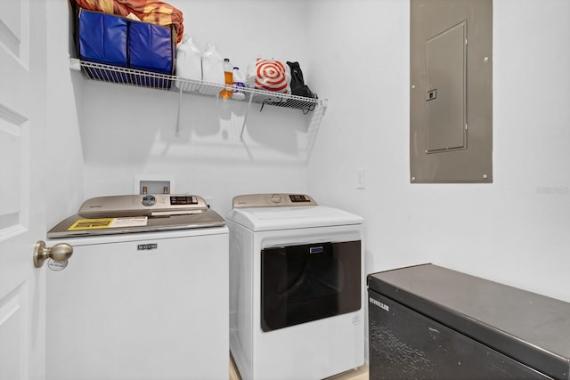 clothes washing area with electric panel and washing machine and clothes dryer