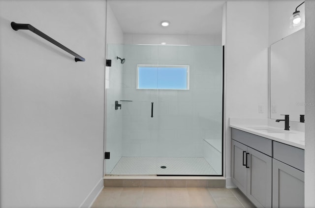 bathroom with tile patterned floors, an enclosed shower, and vanity