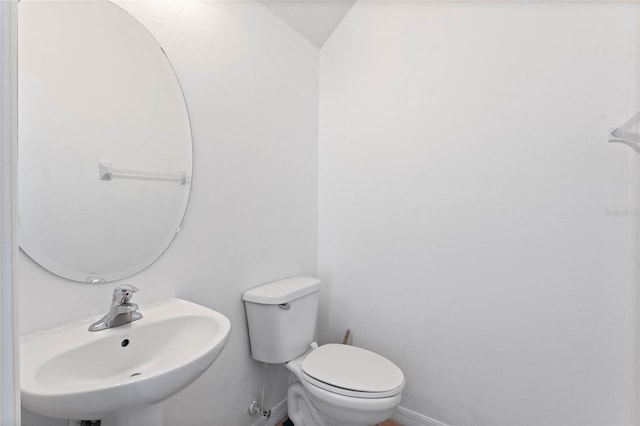 bathroom featuring toilet and sink