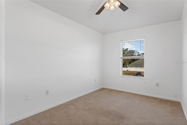 carpeted spare room with ceiling fan