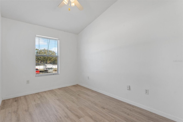 spare room with ceiling fan, lofted ceiling, and light wood-type flooring