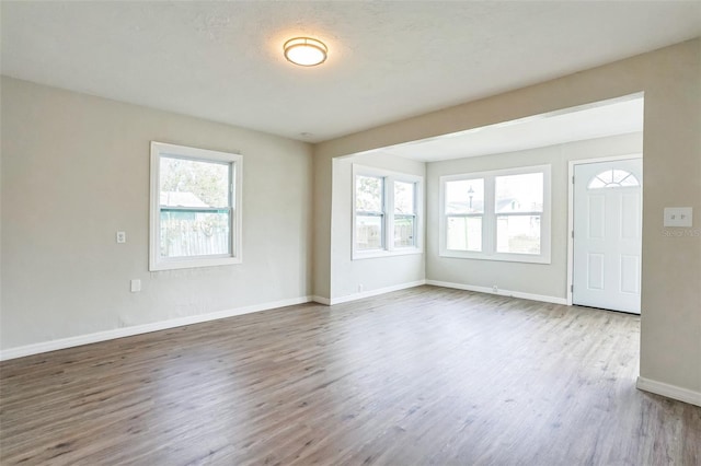 unfurnished room with hardwood / wood-style flooring and a wealth of natural light