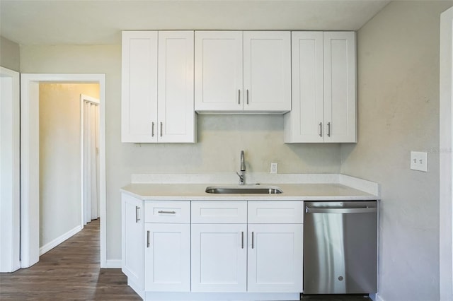 kitchen with white cabinetry, sink, stainless steel dishwasher, and dark hardwood / wood-style floors