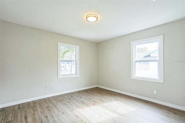 spare room featuring light hardwood / wood-style floors and a wealth of natural light