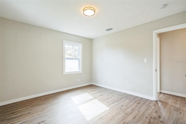 spare room featuring light hardwood / wood-style flooring