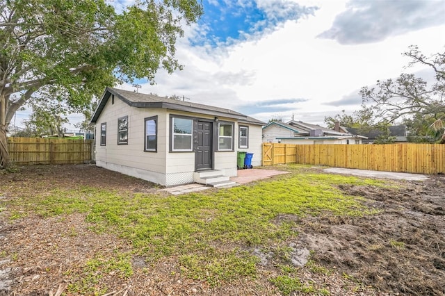 rear view of property with a lawn