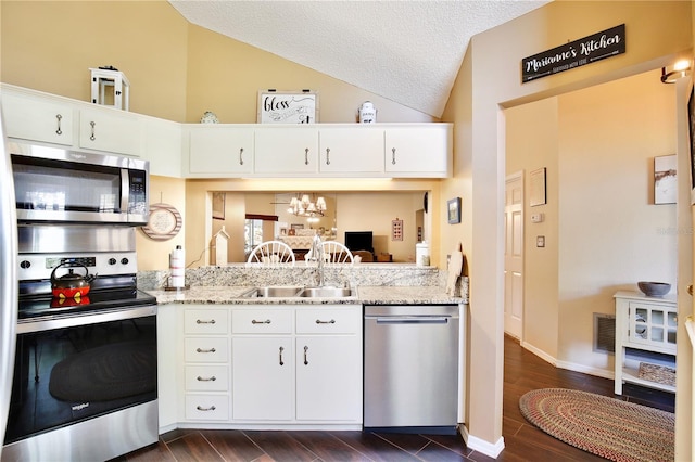 kitchen with sink, light stone counters, white cabinets, and appliances with stainless steel finishes