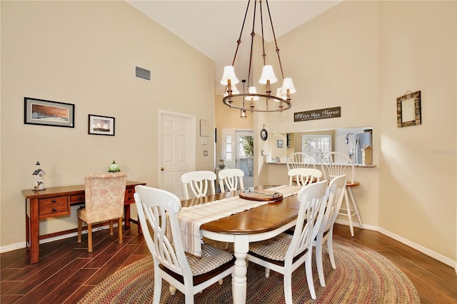 dining room featuring a chandelier and high vaulted ceiling