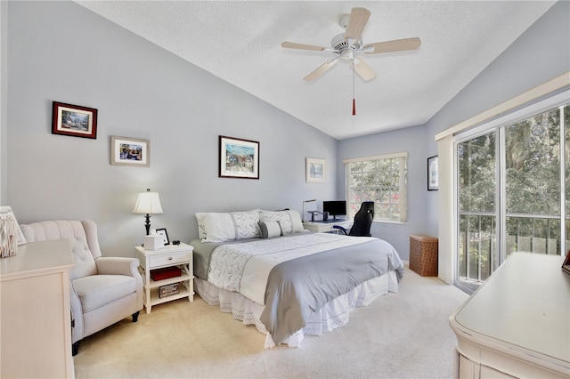 carpeted bedroom with lofted ceiling, a textured ceiling, and ceiling fan