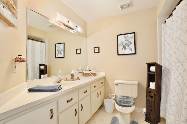 bathroom featuring toilet, tile patterned floors, and vanity