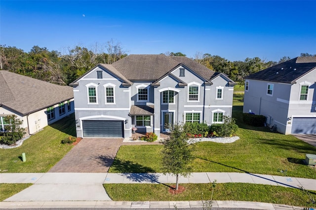 view of front property with a front yard and a garage