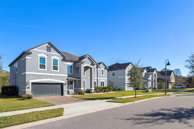 view of front of property with a garage and a front lawn