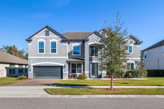 view of front of home featuring a front yard and a garage