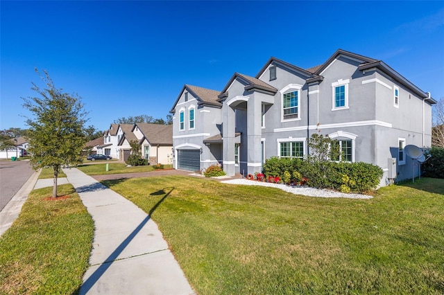 view of front of property featuring a front lawn and a garage