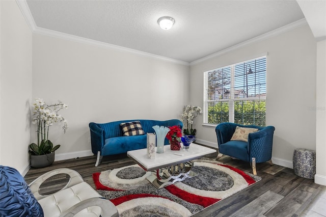 sitting room with a textured ceiling, dark hardwood / wood-style floors, and ornamental molding