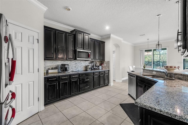 kitchen featuring pendant lighting, sink, light stone countertops, light tile patterned flooring, and stainless steel appliances