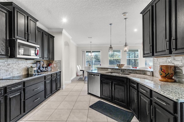 kitchen featuring stainless steel appliances, tasteful backsplash, crown molding, decorative light fixtures, and light tile patterned floors