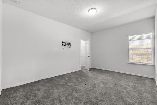 carpeted spare room featuring a textured ceiling