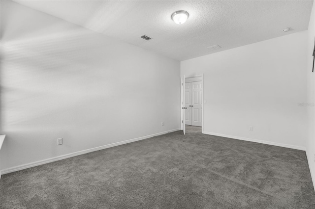 carpeted empty room with a textured ceiling