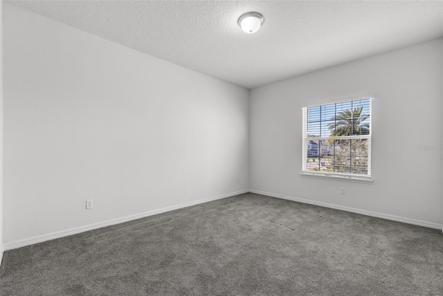 carpeted spare room featuring a textured ceiling