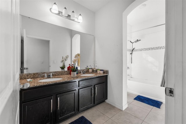 bathroom featuring tile patterned flooring, vanity, and tiled shower / bath