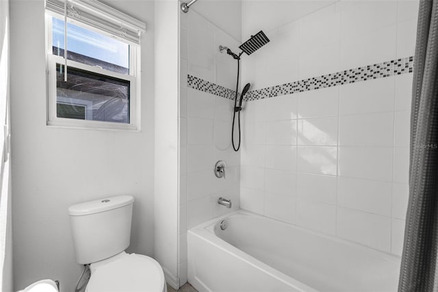 bathroom with toilet and shower / tub combo with curtain