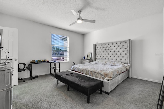 carpeted bedroom with ceiling fan and a textured ceiling