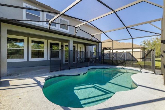 view of swimming pool featuring glass enclosure and a patio