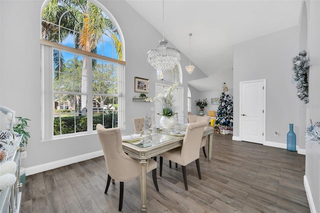 dining space with high vaulted ceiling and an inviting chandelier