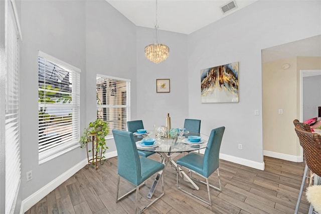 dining space with a chandelier and hardwood / wood-style flooring