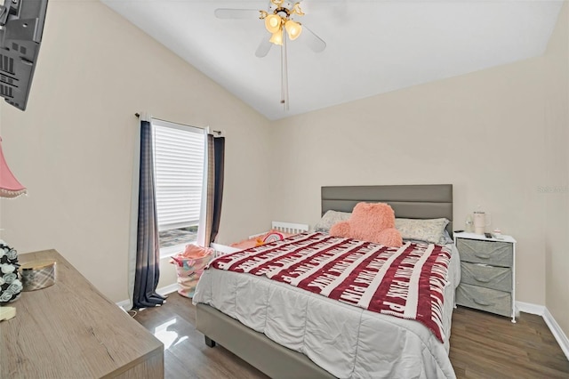 bedroom with ceiling fan, dark hardwood / wood-style floors, and lofted ceiling