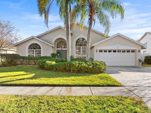 view of front facade with a front yard and a garage