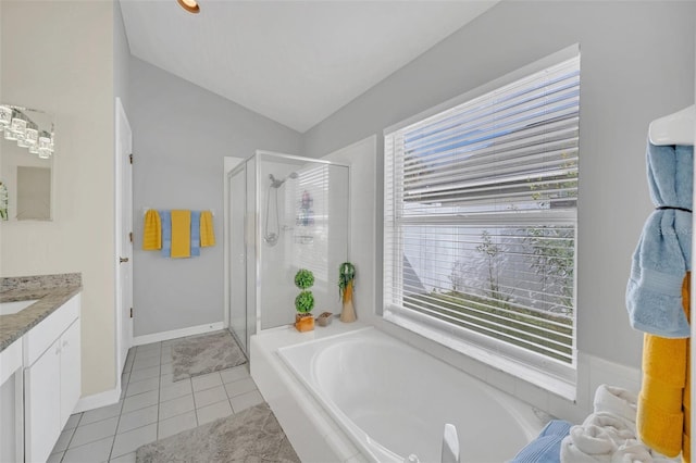 bathroom with independent shower and bath, lofted ceiling, tile patterned floors, and vanity