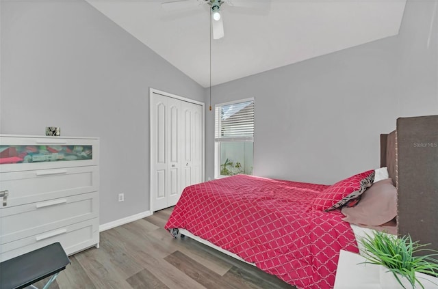 bedroom with lofted ceiling, ceiling fan, a closet, and light hardwood / wood-style flooring