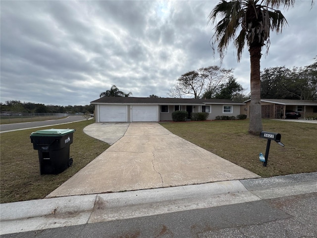 ranch-style home featuring a garage and a front lawn