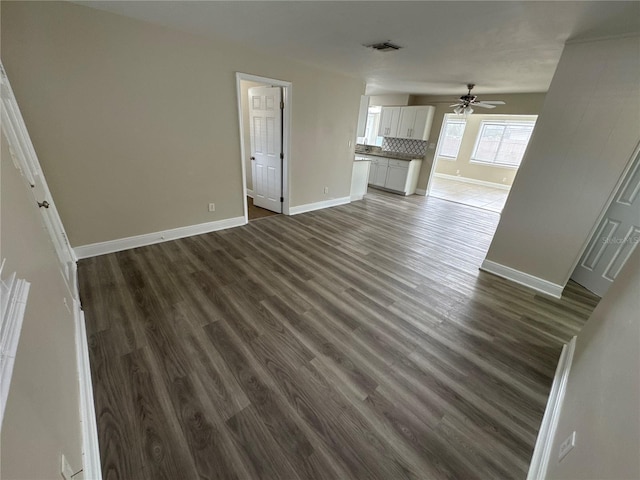 unfurnished living room featuring dark wood-type flooring