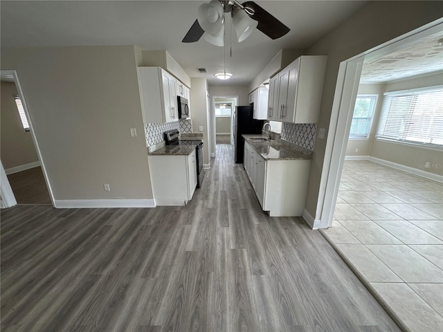 kitchen featuring white cabinetry, sink, ceiling fan, decorative backsplash, and appliances with stainless steel finishes